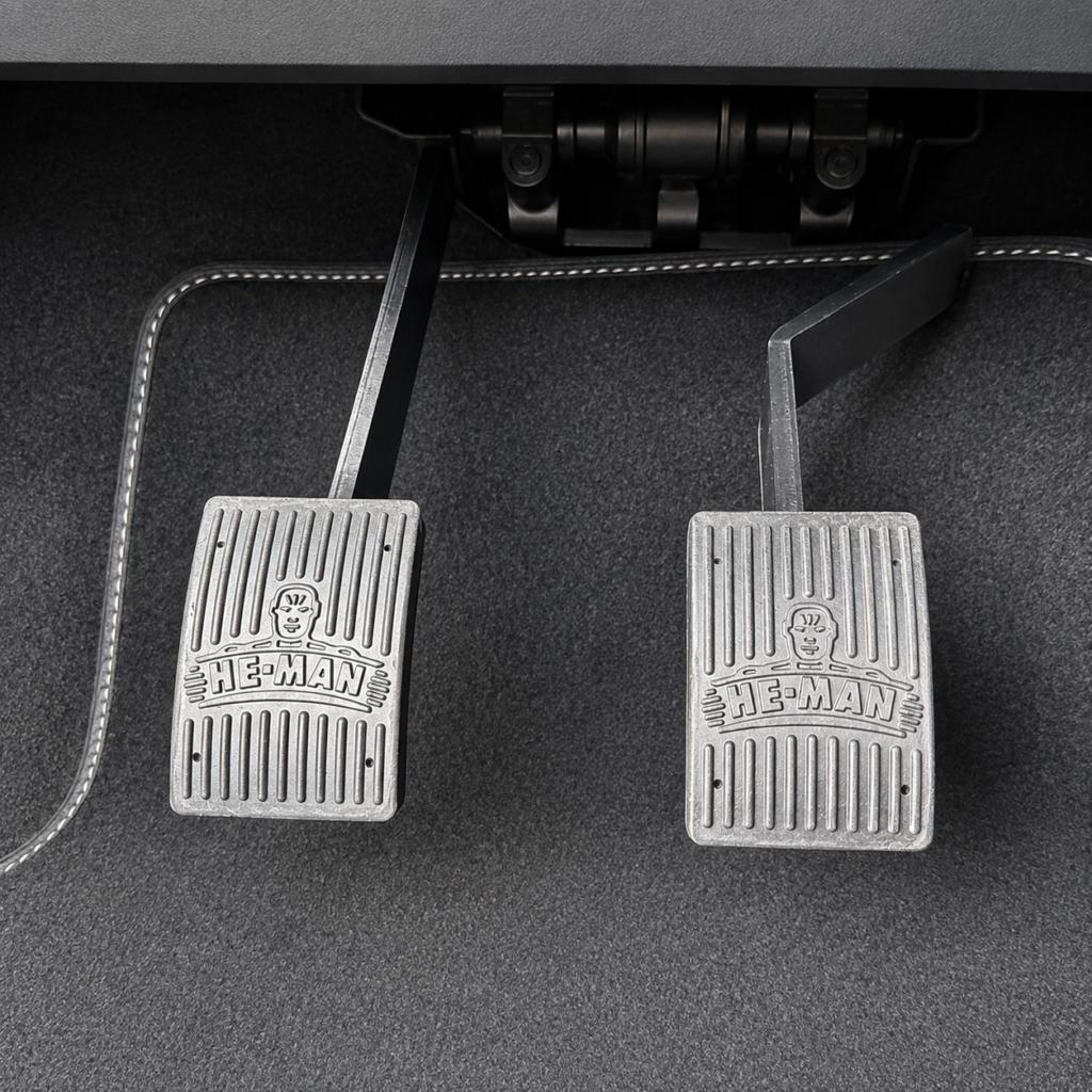 Close-up of dual control pedals fitted in a driving instructor training car