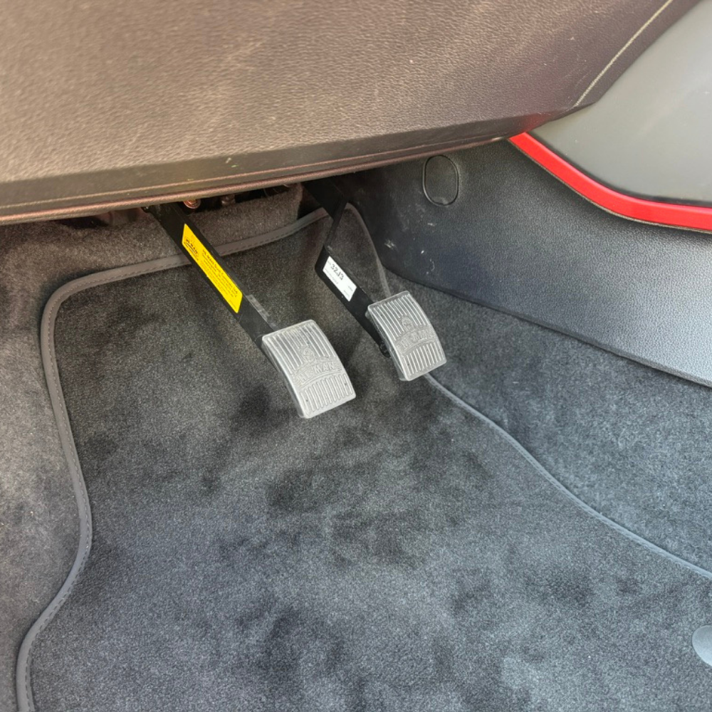 he-man dual control pedals installed in a car
